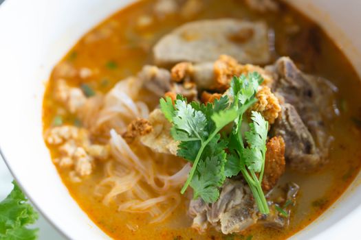 Rice noodle soup with Cooked Liver in  bowl on table, selective focus