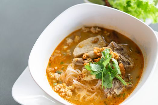 Rice noodle soup with Cooked Liver in  bowl on table, selective focus