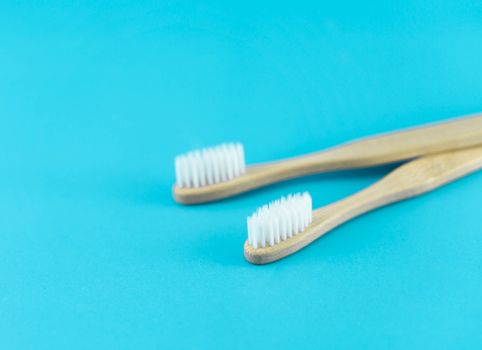 Close up wooden toothbrush on blue background, selective focus