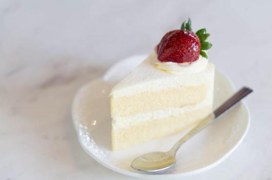Closeup Milk cake delicious on glass table background, selective focus