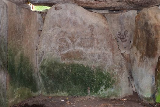 Engravings on stones in the tumulus Mane Lud near Locmariaqur. Tumulus Mane Lud is one of the largest and most important monuments of megalithic culture in Brittany, France