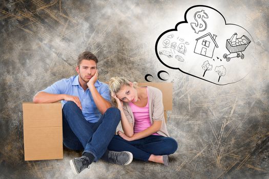 Unhappy young couple sitting beside moving boxes against life thoughts