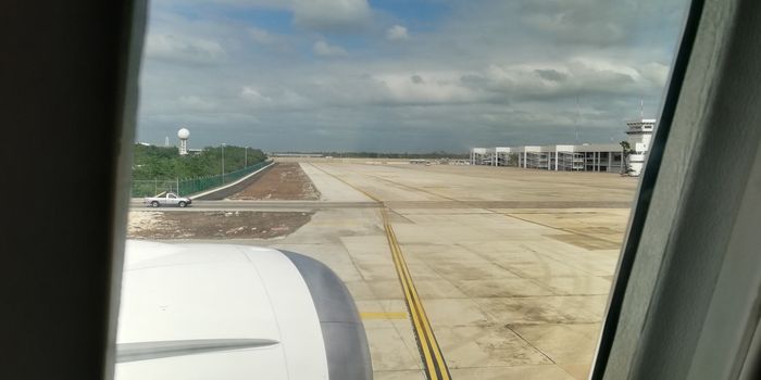 Cancun airport view from a plane during a sunny day