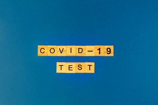 Virus Test of Coronavirus. Prevent or stop the spread of the COVID-19 worldwide. Letters test on blue background. flat lay, flat layout