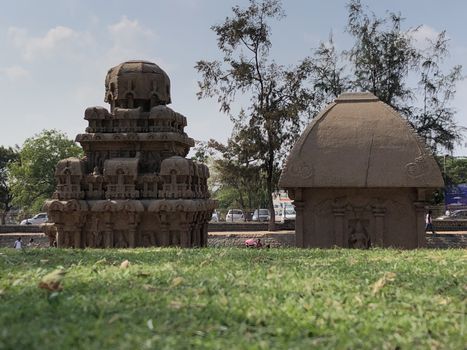 Pancha Rathas is an example of monolith Indian rock-cut architecture. Resembling a chariot ratha, it is carved out of a single, long stone of pink granite. This is one of the Group of Monuments at Mahabalipuram and also a UNESCO World Heritage Site. In this view monuments of Pancha Rathas are beautifully captures from the grass meadow area.