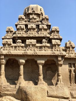 Dharmaraja Ratha is a monument in the Pancha Rathas is an example of monolith Indian rock-cut architecture. Resembling a chariot ratha, it is carved out of a single, long stone of pink granite. This is one of the Group of Monuments at Mahabalipuram and also a UNESCO World Heritage Site. The unfinished structure is dedicated to the Lord Shiva.