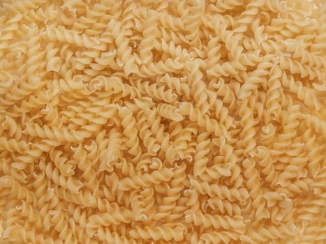 Macro curly in the form of spirals laid out on the table in the form of a background very tightly beautiful yellow appetizing ingredients for cooking