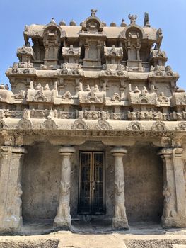 Pancha Rathas is an example of monolith Indian rock-cut architecture. Resembling a chariot ratha, it is carved out of a single, long stone of pink granite. This is one of the Group of Monuments at Mahabalipuram and also a UNESCO World Heritage Site. In this view monuments of Pancha Rathas are beautifully captures from the grass meadow area.