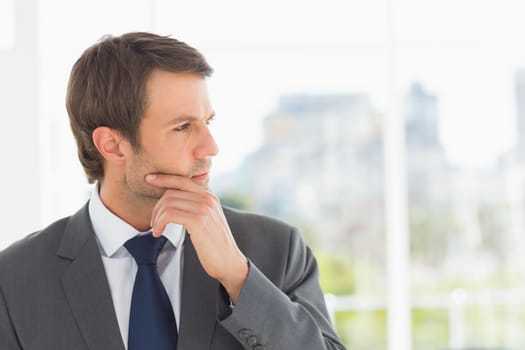 Closeup of a handsome young businessman over blurred background outdoors