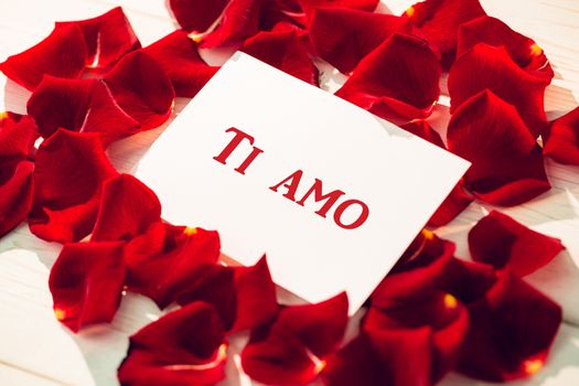 ti amo against card surrounded by rose petals