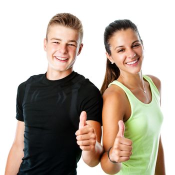 Close up portrait of active teen couple in sportswear doing thumbs up.Isolated on white background.