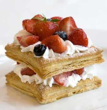 Mini fruit cake with fresh berries. Close up view.