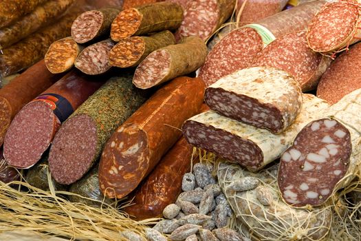 Different types of raw smoked sausage on the store shelf.