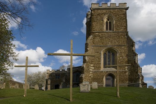 An English Parish Church with 3 crosses outside at Easter time