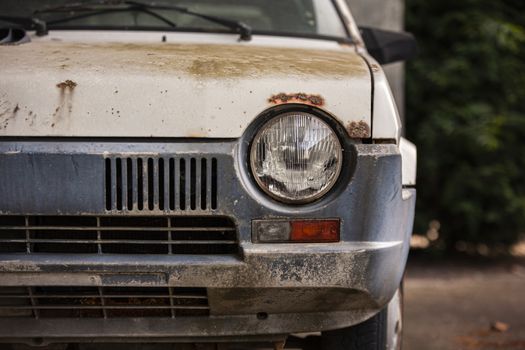 Old abandoned and rusty car exterior detail