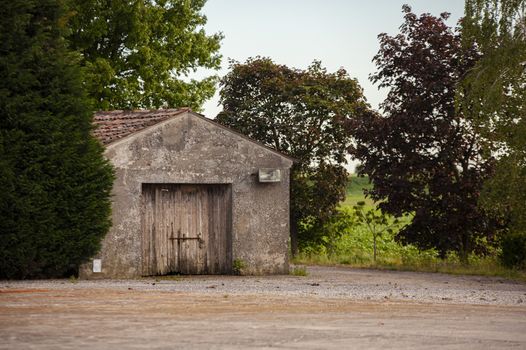 Rural building detail immersed in trees and countryside landscape