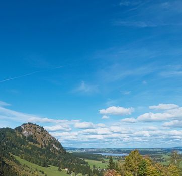 Beautiful nature of European Alps, landscape view of alpine mountains, lake and village on a sunny day, travel and destination scenery
