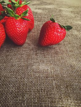 Organic strawberries on rustic linen background, fruit farming and agriculture