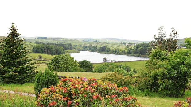 A view across the West Yorkshire countryside towards Lower Raithe Reservoir.  The reservoir is a short distance from the village of Haworth in northern England.