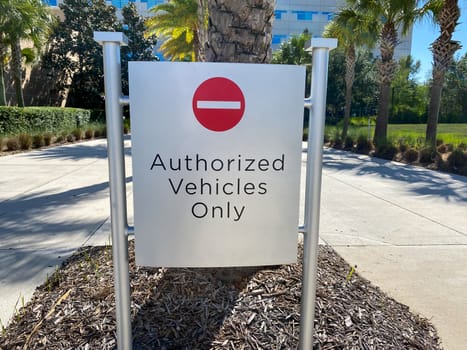 A warning sign that reads "Authorized Vehcles Only" on a street by a university in Orlando, Florida.