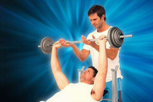 Trainer helping fit man to lift the barbell bench press against abstract background