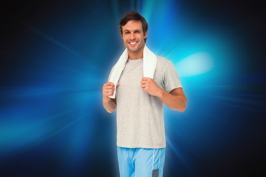 Portrait of a fit young man with towel against abstract background