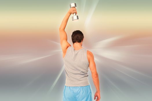 Rear view of a man exercising with dumbbell against abstract background
