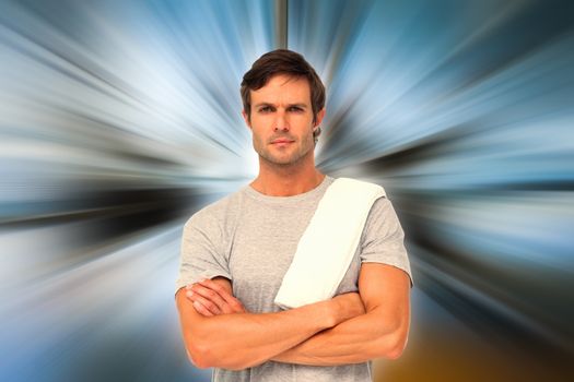 Portrait of a fit young man with towel against abstract background