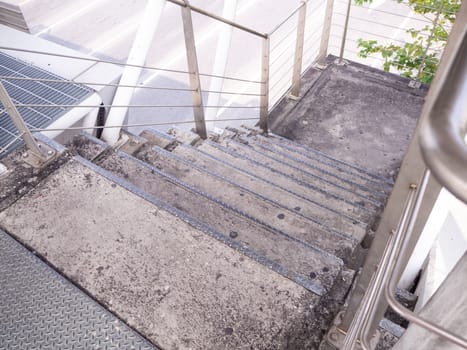 staircase for descending from footbridge. The concrete overpass for crossing the road.