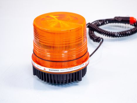 the Orange rotating beacon on white reflective background.