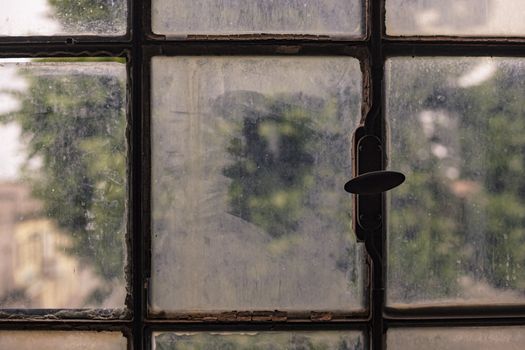 Old, rusty and dirty window detail in an abandoned building