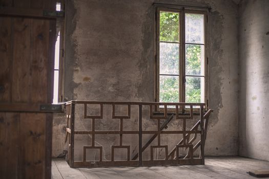 interior of an abandoned building with window and staircase