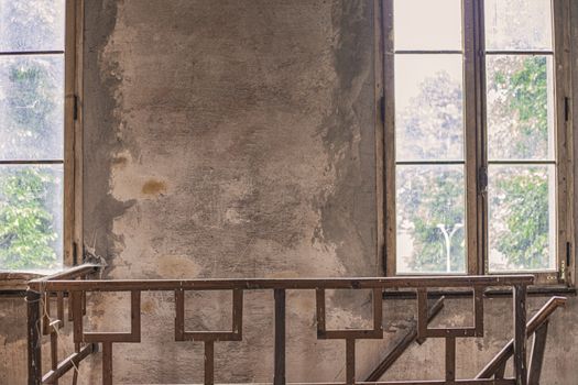 interior of an abandoned building with window and staircase