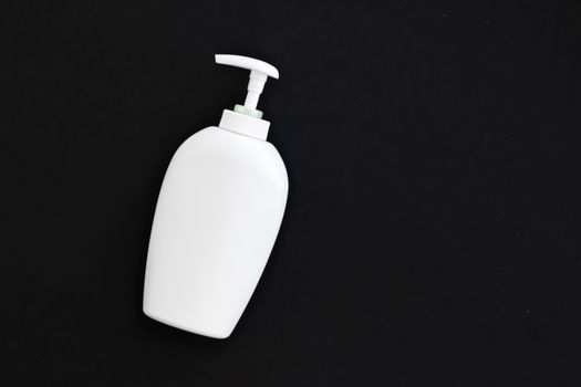 Blank label cosmetic container bottle as product mockup on black background, hygiene and healthcare