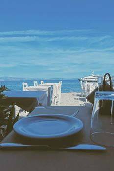 Empty restaurant by the Aegean sea and cruise boat, travel and nature, scene