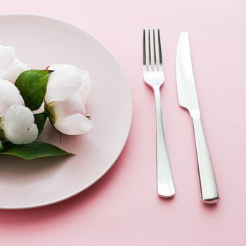 Dining plate and cutlery with peony flowers as wedding decor set on pink background, top tableware for event decoration and menu branding design