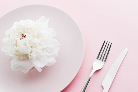 Dining plate and cutlery with peony flower as wedding decor set on pink background, top tableware for event decoration and dessert menu design