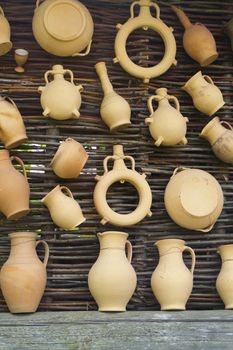 Rustic handmade ceramic clay brown terracotta cups and jug souvenirs collection, vertical image