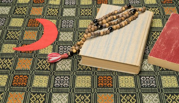 Muslim prayer beads and Quran on the prayer Mat. Islamic and Muslim concepts