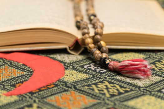 Muslim prayer beads and Quran on the prayer Mat. Islamic and Muslim concepts