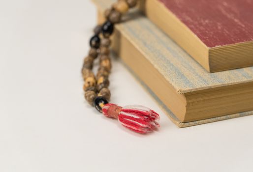 Muslim prayer beads and Quran isolated on a white background. Islamic and Muslim concepts
