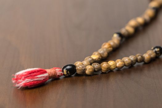 Muslim prayer beads isolated on a wooden background. Islamic and Muslim concepts