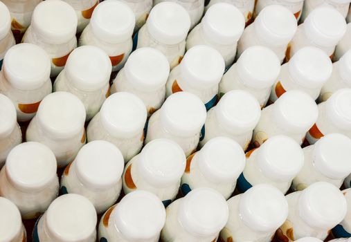 top view of a group of white plastic bottles with dairy products