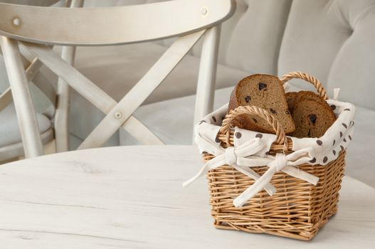 bread in a wicker basket on a light background on a table