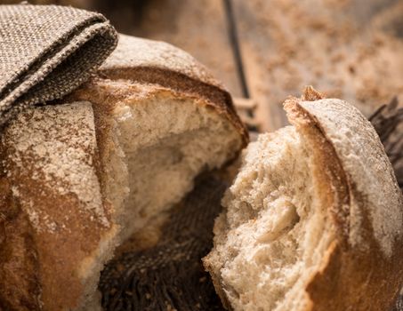 closeup of a broken loaf of bread on a cloth napkin