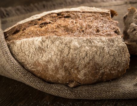 closeup of a broken loaf of bread on a cloth napkin