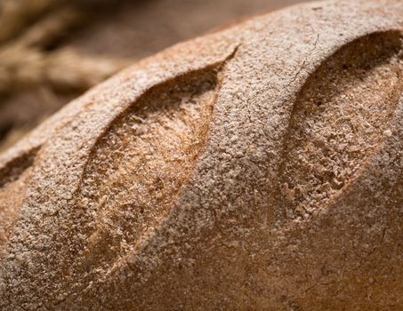 closeup of Golden and loaf of fresh bread