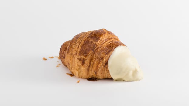 croissant with cream filling on a white background