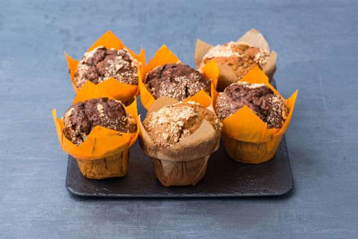 appetizing round cupcakes on a black plate