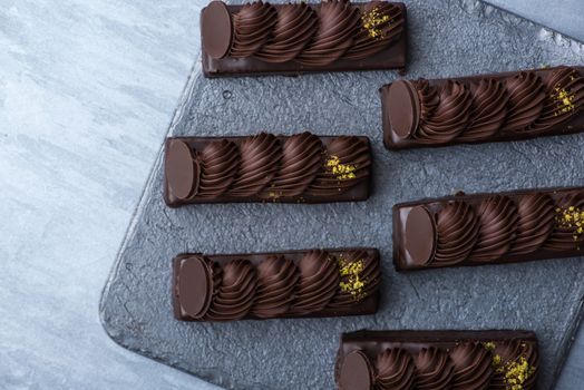 appetizing cake on a black plate, top view